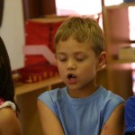 Three children engaged in school prayer
