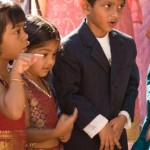 gir;ls in indisan cloths and two boys in kurta nd suit standing together