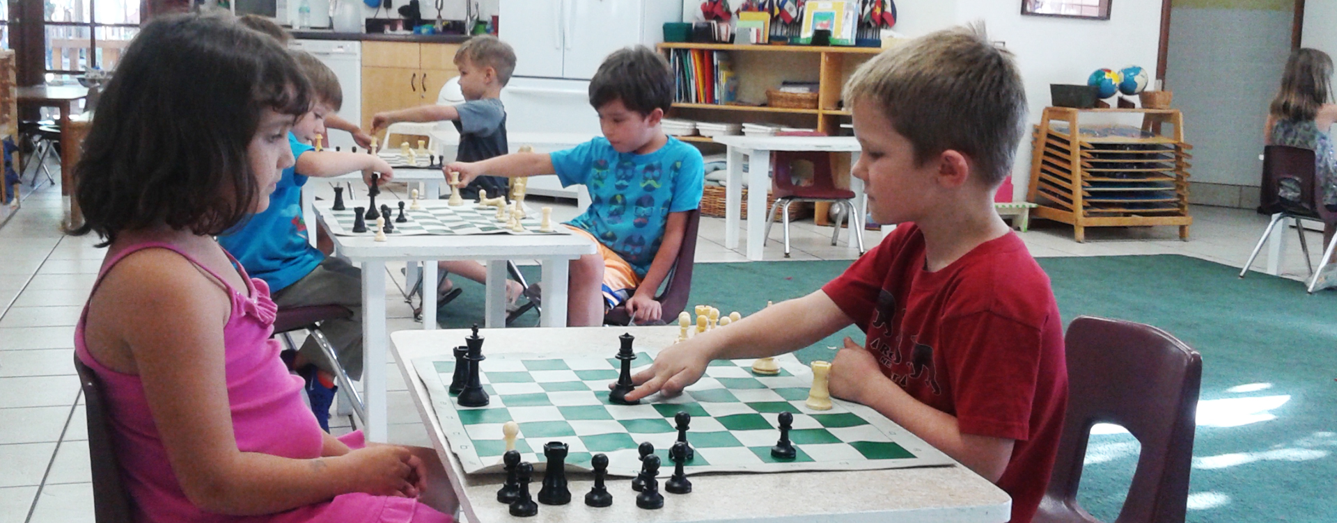 Students playing chess a school