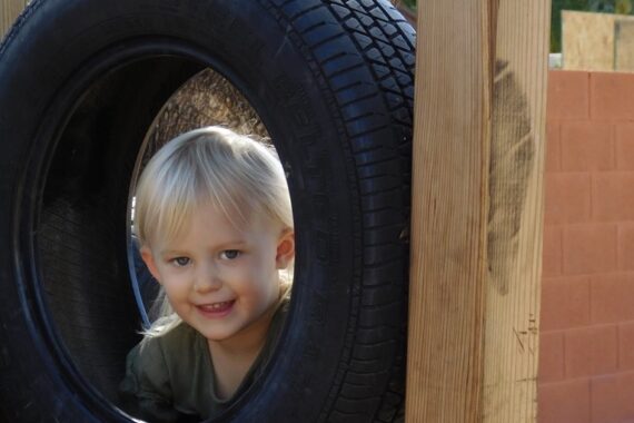 preschooler smiling on playground showing confidence and resilience in children